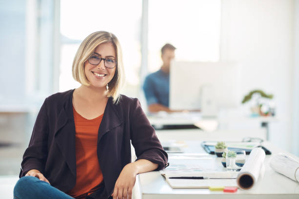 portrait of a young woman working at her desk in a modern office